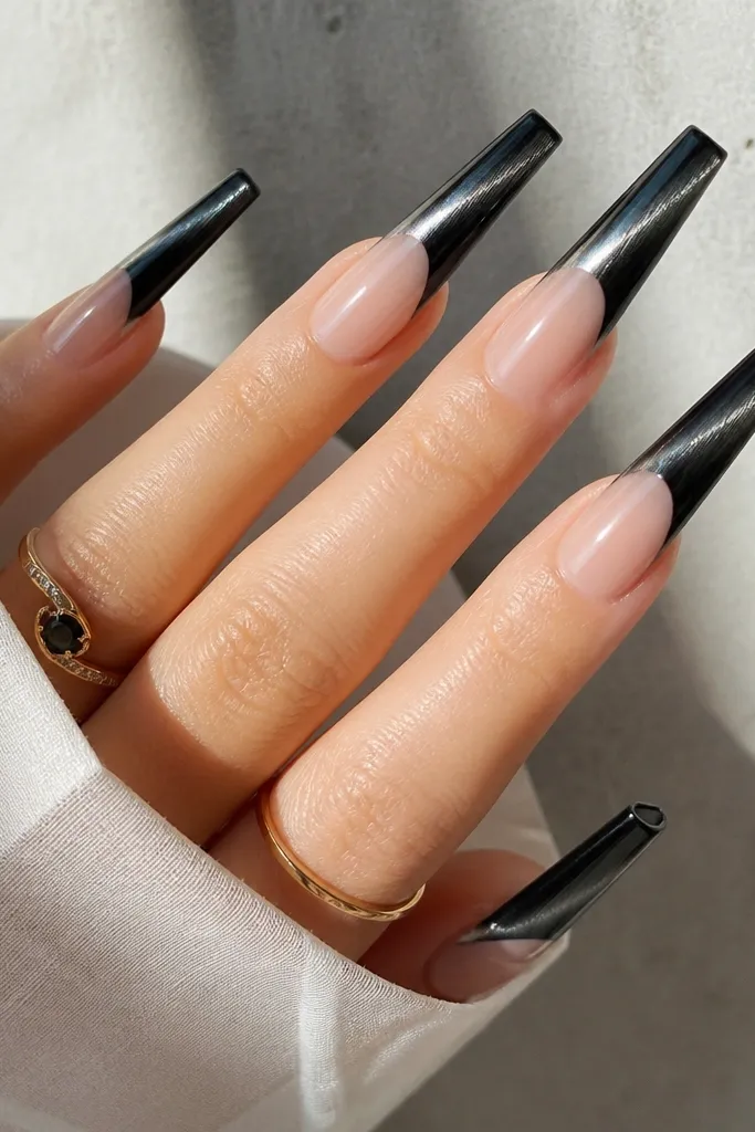 Extra-long coffin nails with a sheer base and black cat eye French tips that wrap slightly over the nail edge. The cat-eye stripe runs vertically and looks brightest near the center of the black area, with a sharp glossy finish.