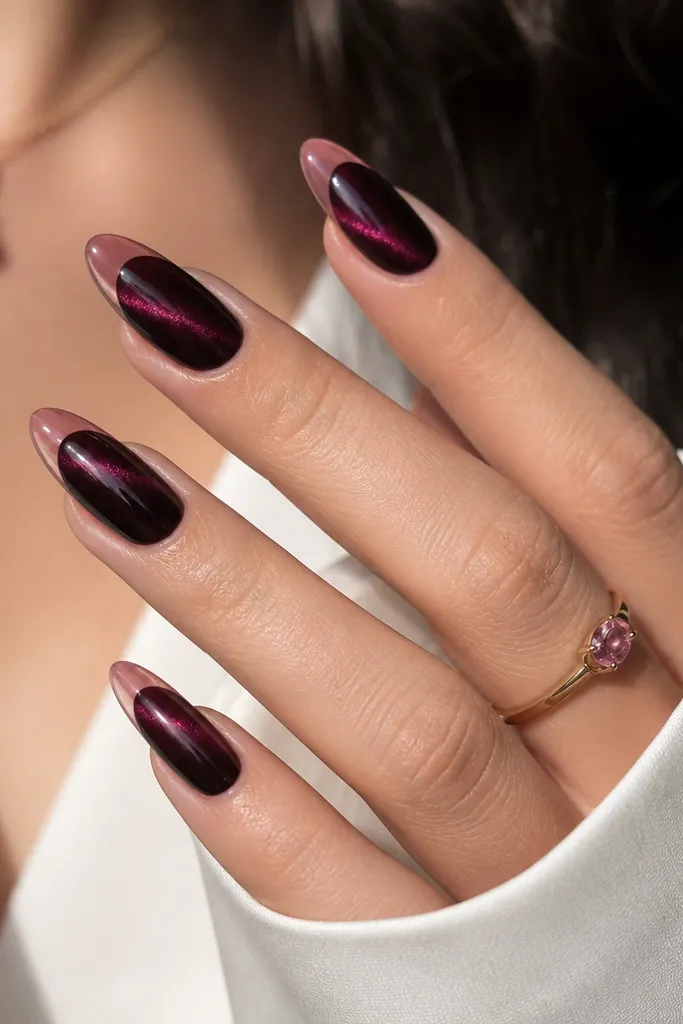 Deep black cherry cat-eye nails with a magenta-purple magnetic stripe. The french tips are a semi-sheer rose pink, edged neatly and slightly translucent rather than opaque.