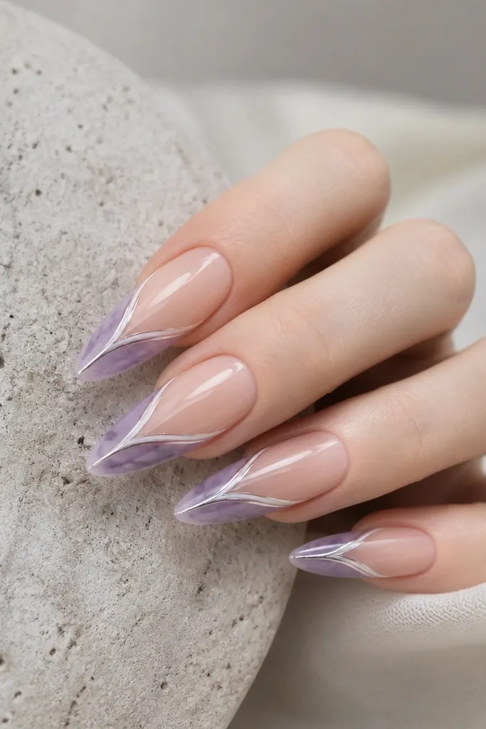 Lavender smoke cat-eye nails with a silver-lilac stripe. The french tips form a V-shape down the center with a white line, leaving the sides mostly nude.