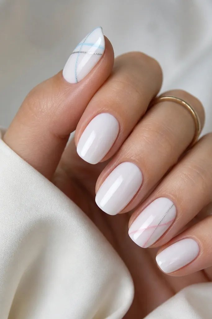 Icy white gel on all nails with a glossy finish. On two nails (thumb and ring finger), there are diagonal thin lines crossing the nail - one nail has pale blue and silver lines, the other has pale pink and silver lines.