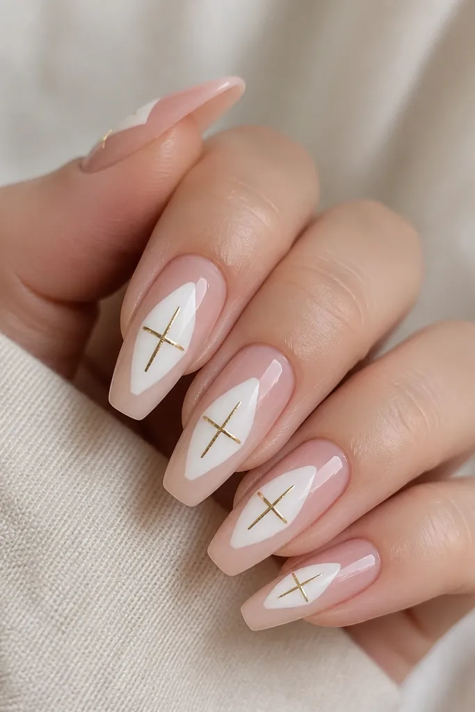 Medium coffin nails. The base is translucent nude so the natural nail tone shows through. There are sharp white geometric blocks in the center, leaving negative space around them. Over the white blocks are small gold bar crosses, like tiny plus signs made of thin gold strips. The finish is glossy.