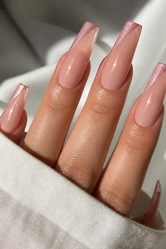 Long coffin nails with a blush nude base. French tips are blush pink cat eye with a magnetic line angled slightly to one side, glossy finish.