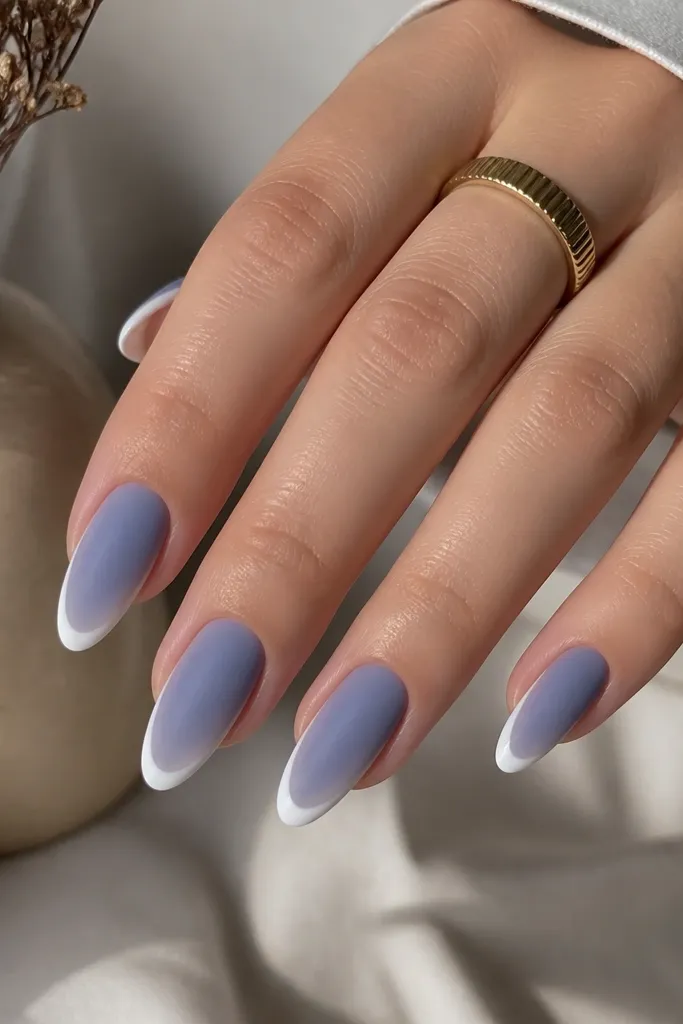 Almond nails with a periwinkle magnetic stripe down the center, white French tips, and a matte finish that kills the shine. The cat eye still shows a faint moving highlight under light.