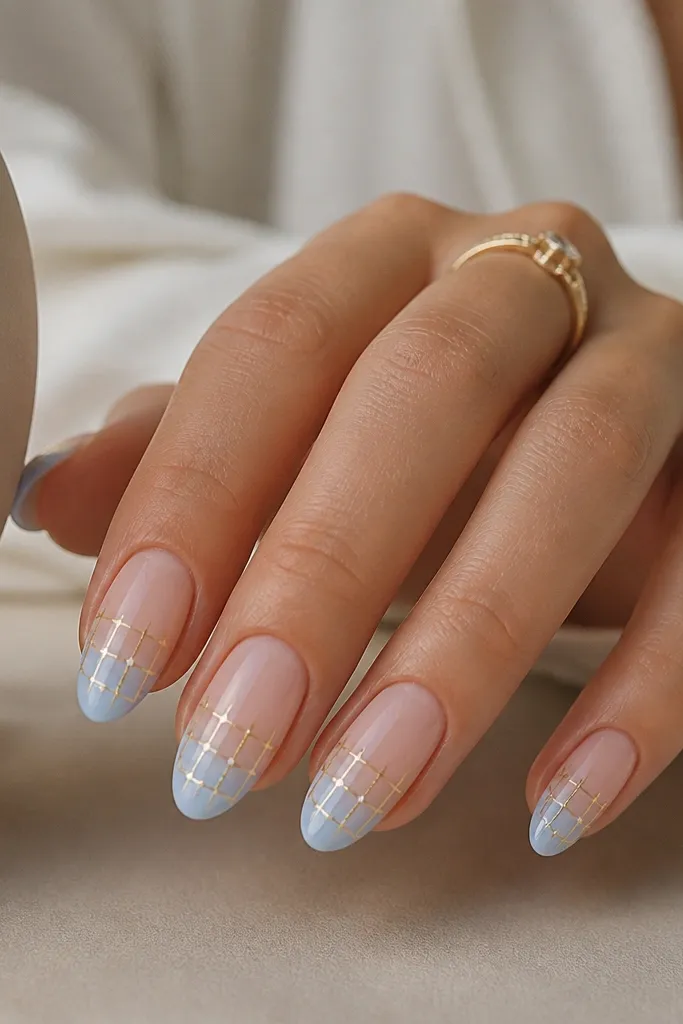 Medium almond nails with a soft sky blue gradient only on the tips. A thin gold grid sits in the middle, and small white dots fill the grid intersections like light nodes.