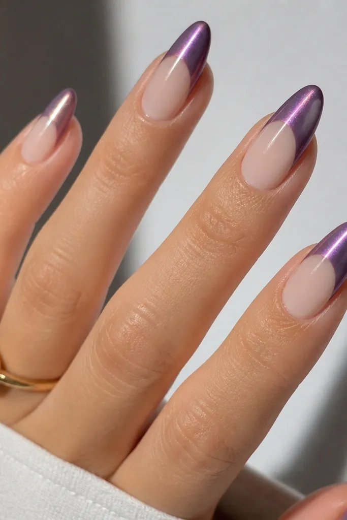 Almond nails with a clear negative space near the cuticle. Base is sheer. French tips are violet smoke chrome cat-eye with a bright purple stripe down the center. The negative space makes the tips look floating.