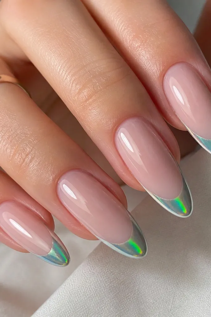 Long almond nails with a sheer nude base. French tips are aurora green chrome cat-eye, showing a bright green stripe in the center. The surrounding tip shifts toward silver and sometimes teal under flash. The finish looks crystal-clear and glassy.