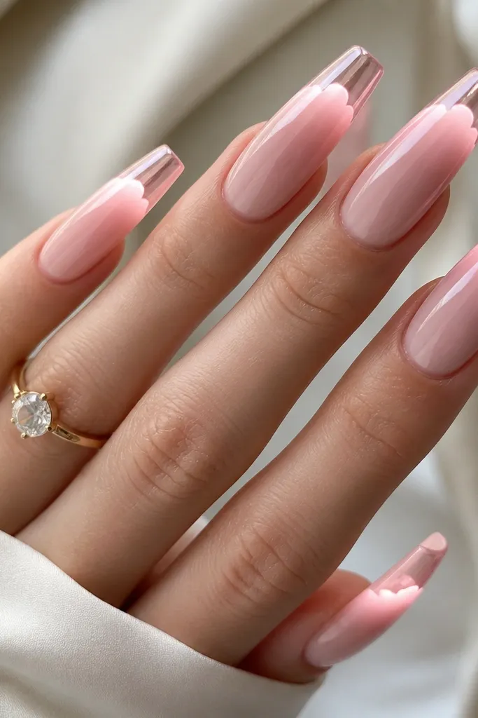 Long coffin nails with soft pink cloud-shaped chrome tips. Under the clear top coat, a subtle LED glow sits beneath the cloud area, making the chrome look lit from within. The nail bed is pale pink and glossy.