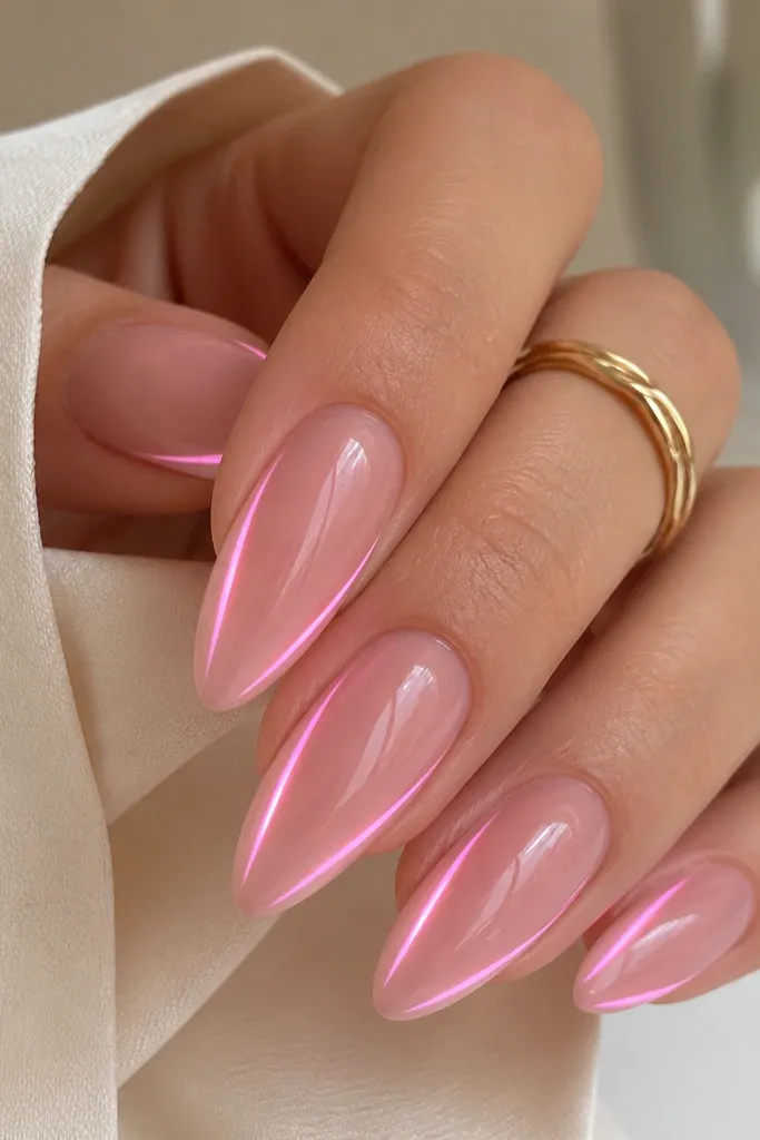 Long almond nails in a glossy pink ombré. Two faint LED glow lines run along each side near the tip, like ribbons, while the center stays solid pink. The overall look is smooth and shiny.