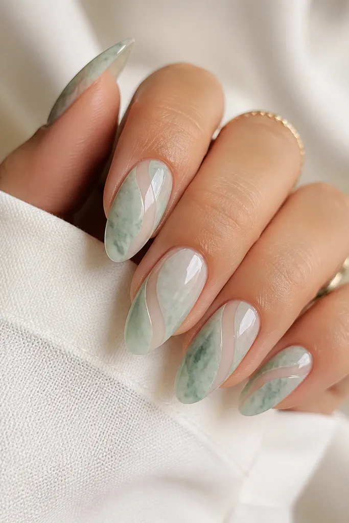 Almond nails with a seafoam green marble effect. Thin clear tape lines create negative-space channels that run vertically and diagonally. The base is semi-translucent and the finish is glossy.