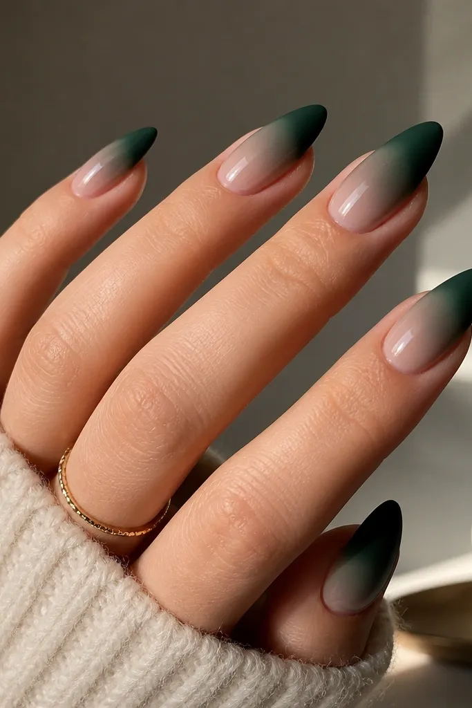 Almond nails with a smooth gradient from sheer nude near the cuticle to deep evergreen at the tips. The tips have a matte finish, while the rest is glossy and reflective.