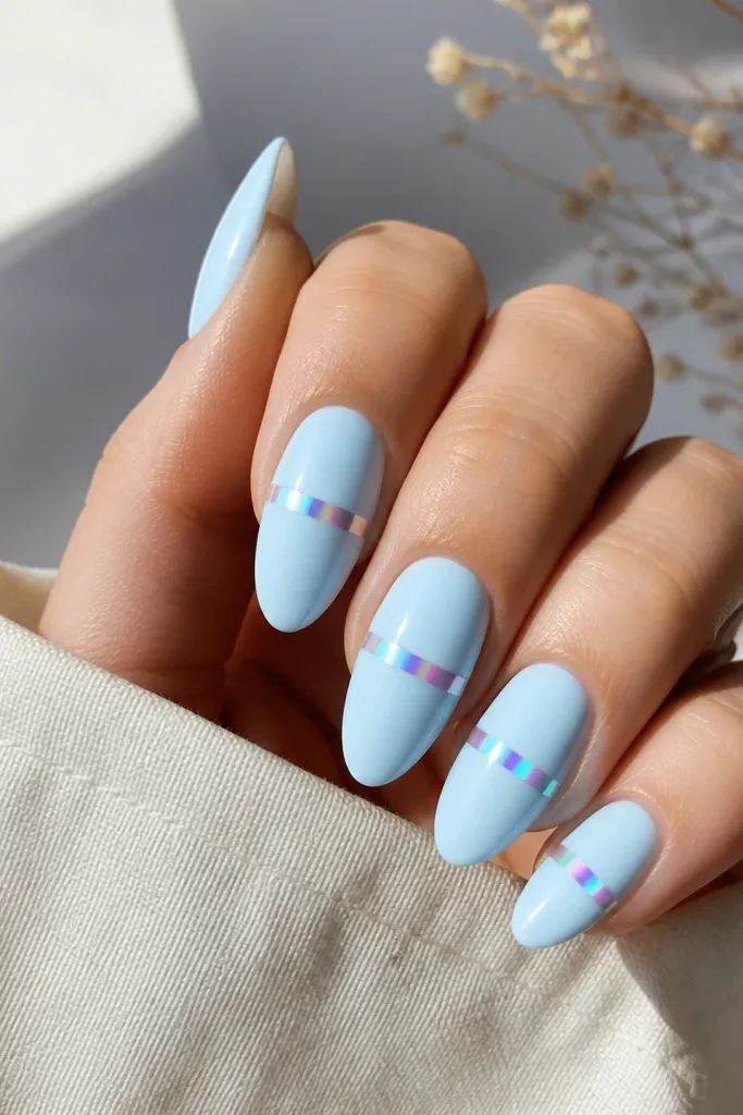 Almond nails with a pale icy blue base. A single horizontal chrome stripe across each nail shifts between teal and pink under light, creating an aurora effect.