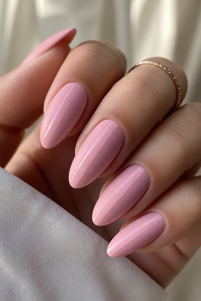Almond nails in baby pink. The overall finish is matte, but each nail has a glossy vertical center strip that runs from near the cuticle to the tip. Side areas are fully matte, with crisp contrast.